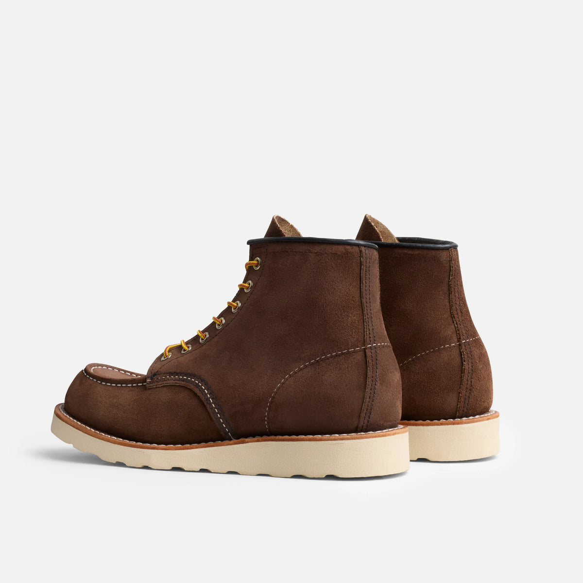 Pair of brown leather boots on a light gray background