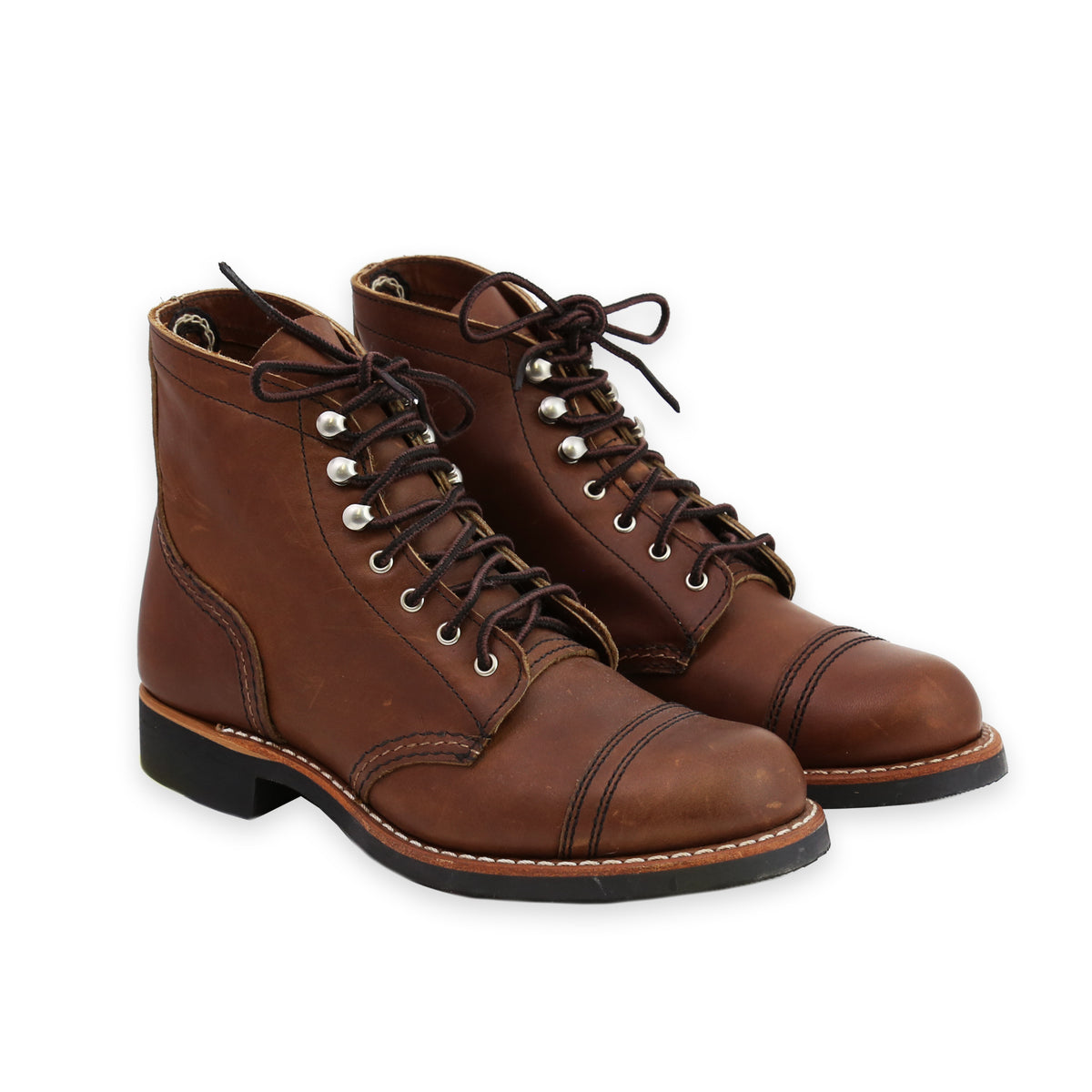 Front Angle of A pair of women's brown leather boots with lace-up closure and a Vibram sole pattern.
