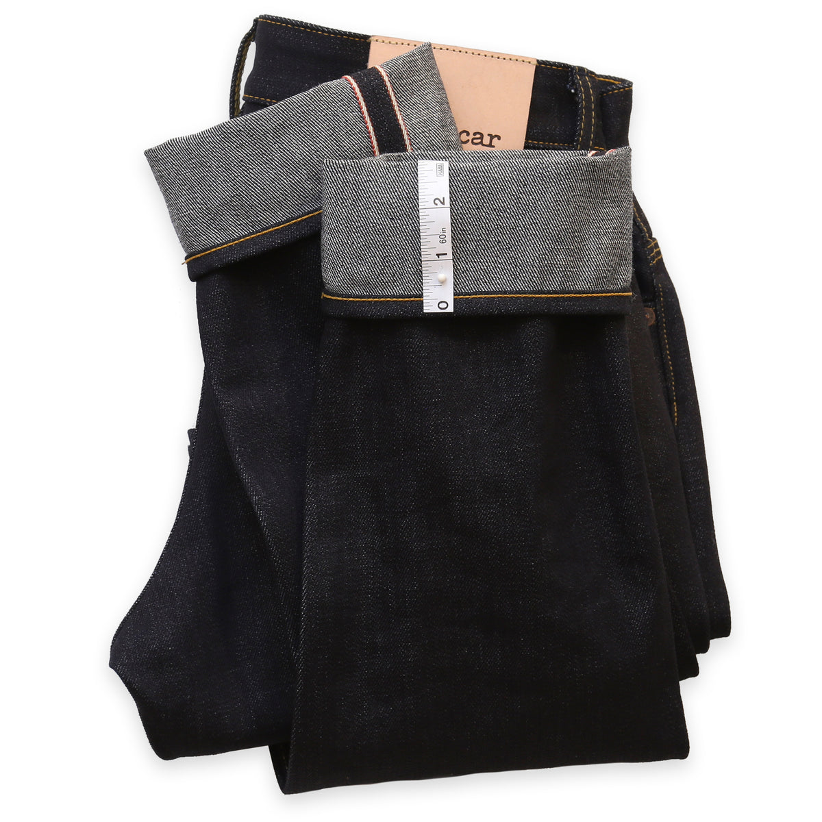 A pair of jeans laid out flat showing the hem area, with the brand name 'Railcar' visible on the tag.